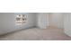 Bright bedroom featuring neutral carpet, white walls, and a sunlit window at 42945 W Palo Amarillo Rd, Maricopa, AZ 85138