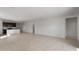 Spacious living room with tile flooring and an open layout connecting to the modern kitchen at 42945 W Palo Amarillo Rd, Maricopa, AZ 85138
