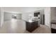Expansive kitchen, living, and dining area featuring granite countertops, stainless appliances, and ample sunlight at 42945 W Palo Amarillo Rd, Maricopa, AZ 85138