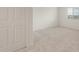 Bedroom featuring neutral carpet, a door, and a window providing ample sunlight and space at 42950 W Palo Amarillo Rd, Maricopa, AZ 85138