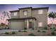 Two story home featuring a two car garage, stucco finish, and stone accents at 42950 W Palo Amarillo Rd, Maricopa, AZ 85138