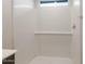 Close-up of the tiled shower with bench seating and a window for natural light at 42950 W Palo Amarillo Rd, Maricopa, AZ 85138