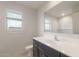 Bright bathroom features a modern vanity, a large mirror, and a window with natural light at 42955 W Palo Amarillo Rd, Maricopa, AZ 85138
