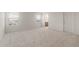 Spacious bedroom features neutral carpet, two windows for ample natural light, and an ensuite bathroom at 42955 W Palo Amarillo Rd, Maricopa, AZ 85138