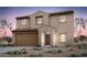 Two-story home featuring a two-car garage, brown wood door, red tile roof, and desert landscaping at 42955 W Palo Amarillo Rd, Maricopa, AZ 85138