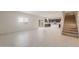 Bright and open living area with tile floors leading into a modern kitchen with dark cabinetry at 42955 W Palo Amarillo Rd, Maricopa, AZ 85138