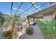 Inviting back patio with a pergola, lush plants, and outdoor decor, perfect for relaxation and outdoor enjoyment at 4418 W Palo Verde Ave, Glendale, AZ 85302