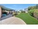 Lush backyard with ample green space, covered patio, and outdoor seating, creating a serene outdoor retreat at 4418 W Palo Verde Ave, Glendale, AZ 85302