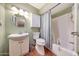 Cozy bathroom featuring a white vanity, medicine cabinet, and tub/shower combo at 4418 W Palo Verde Ave, Glendale, AZ 85302