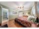 Inviting bedroom with wood floors, a ceiling fan, and soothing green walls at 4418 W Palo Verde Ave, Glendale, AZ 85302