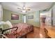 Comfortable bedroom featuring hardwood floors, ceiling fan, and natural light at 4418 W Palo Verde Ave, Glendale, AZ 85302
