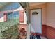 Inviting front entrance with a white door, side window and red shutters at 4418 W Palo Verde Ave, Glendale, AZ 85302