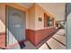 Covered front porch with red brick accents, security door and brick mailbox at 4418 W Palo Verde Ave, Glendale, AZ 85302