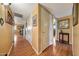 Hallway with wood flooring, white doors, and warm-toned walls at 4418 W Palo Verde Ave, Glendale, AZ 85302