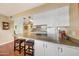 Spacious kitchen with a large island, modern cooktop and overhead lighting at 4418 W Palo Verde Ave, Glendale, AZ 85302