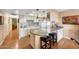 Traditional kitchen with eat-in island, pendant lights, and white cabinetry at 4418 W Palo Verde Ave, Glendale, AZ 85302