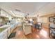 Eat-in kitchen with skylight, white cabinetry, and a breakfast nook area at 4418 W Palo Verde Ave, Glendale, AZ 85302