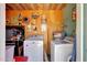 Functional laundry room with modern washer and dryer, utility sink, and storage solutions for efficient organization at 4418 W Palo Verde Ave, Glendale, AZ 85302