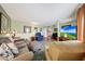 Bright living room with an open floorplan, neutral tones and modern television at 4418 W Palo Verde Ave, Glendale, AZ 85302