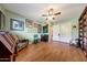 A bright living room with hardwood floors and a ceiling fan, offering ample space and natural light at 4418 W Palo Verde Ave, Glendale, AZ 85302