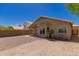 Backyard view highlighting the home's covered patio, desert landscape and sliding glass doors at 4526 E Bannock St, Phoenix, AZ 85044