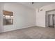 Neutral bedroom with carpet flooring, a window with a view, and access to other areas at 4526 E Bannock St, Phoenix, AZ 85044