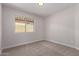Bedroom featuring a window providing natural light and soft carpet flooring at 4526 E Bannock St, Phoenix, AZ 85044