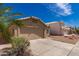 Exterior showing home featuring a two-car garage and manicured landscaping at 4526 E Bannock St, Phoenix, AZ 85044
