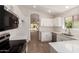 Kitchen features a new stainless dishwasher, microwave, and white cabinets with stone countertops at 4526 E Bannock St, Phoenix, AZ 85044