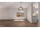 Neutral living space featuring wood-look floors, recessed lighting, and a view of the kitchen area at 4526 E Bannock St, Phoenix, AZ 85044