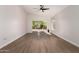 Bright living room featuring wood floors, a ceiling fan, and sliding glass doors to the outdoor space at 4526 E Bannock St, Phoenix, AZ 85044