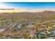 Expansive aerial view of a residential area with winding roads surrounded by mountain views at sunset at 5626 E Sleepy Ranch Rd, Cave Creek, AZ 85331