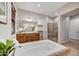 Bright bathroom with soaking tub, walk-in shower, dual sinks, and neutral tones at 5626 E Sleepy Ranch Rd, Cave Creek, AZ 85331