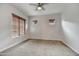 Comfortable bedroom with two windows, neutral carpet and ceiling fan at 5626 E Sleepy Ranch Rd, Cave Creek, AZ 85331