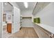 Walk-in closet with shelving, neutral carpet, and easy access to the bathroom at 5626 E Sleepy Ranch Rd, Cave Creek, AZ 85331