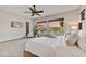 Bright main bedroom featuring carpet floors, ceiling fan, large windows with a view, and ample space at 5626 E Sleepy Ranch Rd, Cave Creek, AZ 85331