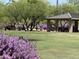 Community park featuring manicured lawns, flowering shrubs, and shade trees at 5626 E Sleepy Ranch Rd, Cave Creek, AZ 85331