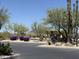 Community parking lot surrounded by flowering bushes and trees at 5626 E Sleepy Ranch Rd, Cave Creek, AZ 85331