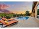 Backyard pool features lounge chairs, mature landscaping, and an iron fence, offering a private oasis at 5626 E Sleepy Ranch Rd, Cave Creek, AZ 85331