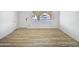 A spacious room with light wood flooring and a large window at 5918 S Parkside Dr, Tempe, AZ 85283