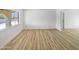 A spacious room with light wood flooring and a large window at 5918 S Parkside Dr, Tempe, AZ 85283