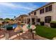 Beautiful backyard with lush landscaping, a pool, patio area, and charming outdoor space at 5993 W Topeka Dr, Glendale, AZ 85308