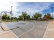 Well-maintained outdoor basketball court with lighting for evening play and recreation at 5993 W Topeka Dr, Glendale, AZ 85308