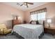 Cozy bedroom with a queen bed, wooden dresser, and a bright window for natural light at 5993 W Topeka Dr, Glendale, AZ 85308