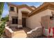 Inviting front entryway with decorative brickwork, desert plants, and a secure screen door at 5993 W Topeka Dr, Glendale, AZ 85308