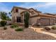 Charming home with desert landscaping featuring mature cacti, stone pathway, and desert plants at 5993 W Topeka Dr, Glendale, AZ 85308