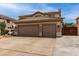 Exterior view of a two-story home featuring a three-car garage and well-maintained landscaping at 5993 W Topeka Dr, Glendale, AZ 85308