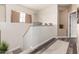 Bright hallway with hardwood floors, decorative planters, and a view of the landing at 5993 W Topeka Dr, Glendale, AZ 85308