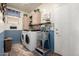 Functional laundry room with washer, dryer, wash basin, storage cabinets and convenient shelving at 5993 W Topeka Dr, Glendale, AZ 85308
