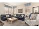 Cozy living room with comfortable seating, large windows, and neutral color palette at 5993 W Topeka Dr, Glendale, AZ 85308